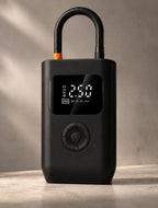 Portable cordless tire inflator with digital pressure display, black compact design